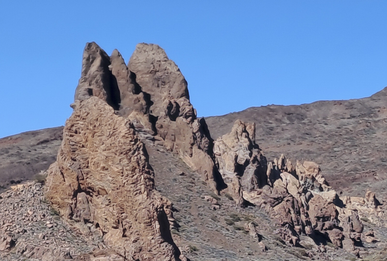 Jagged volcanic rock spires rising from Kernowek Reach's settled highland band