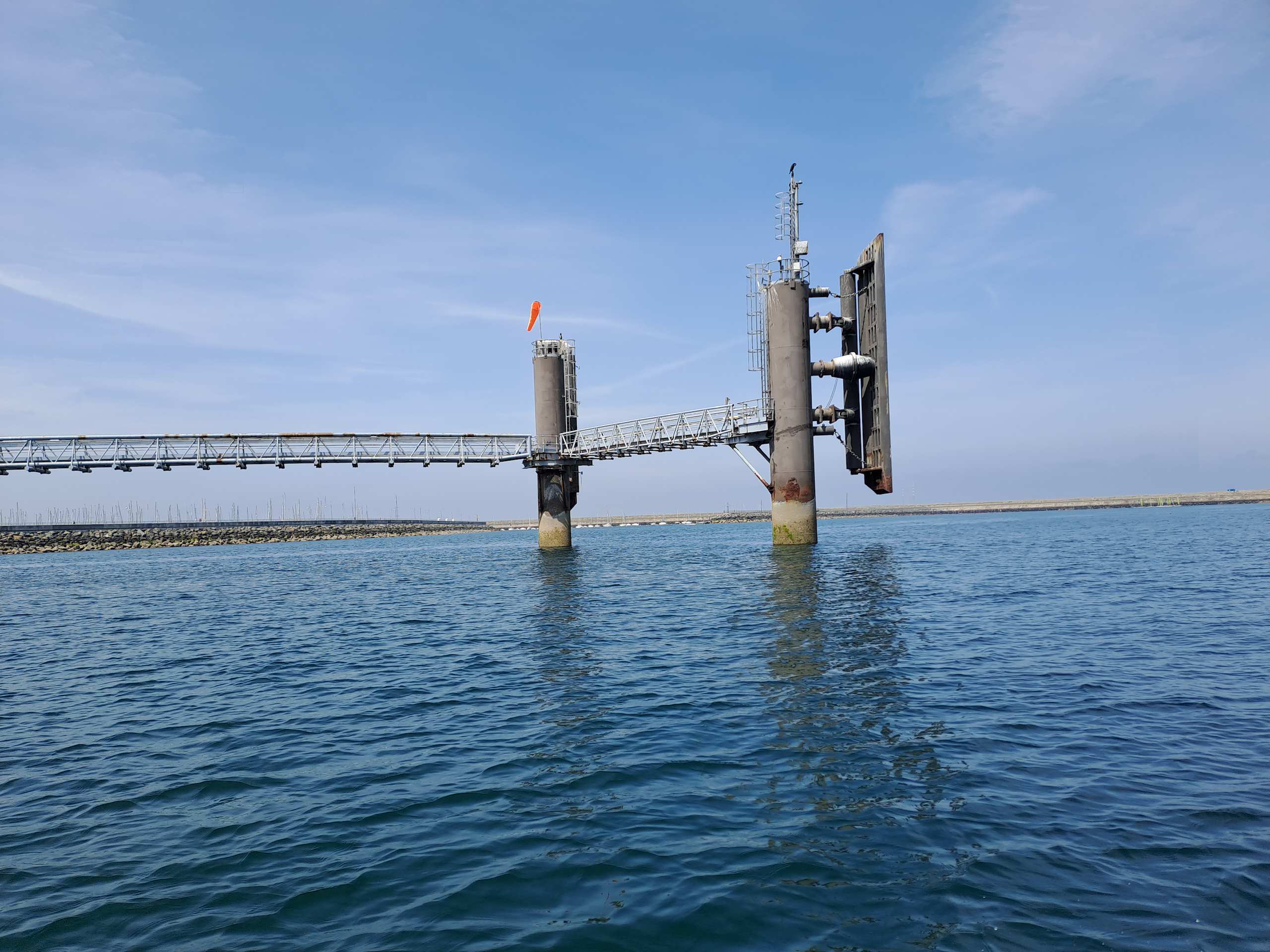 A mooring gantry standing in open water off New Venice's platform breakwater